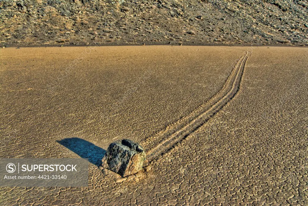'Sailing stones' geological phenomenon of rocks moving along tracks on valley floor, The Racetrack (Valley of Sliding Stones), Death Valley N.P., Mojave Desert, California, U.S.A., april