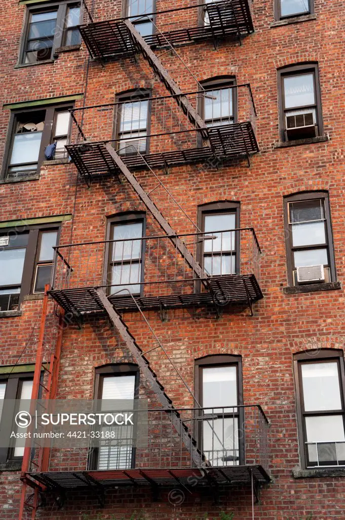 Fire escape ladders on side of brick apartment buildings, New York City, New York State, U.S.A., september