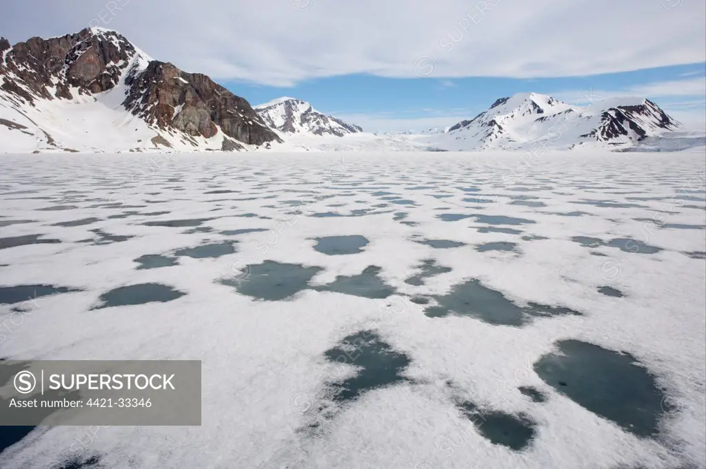 View of sea ice and snow covered coastal mountains, Spitsbergen, Svalbard, late spring