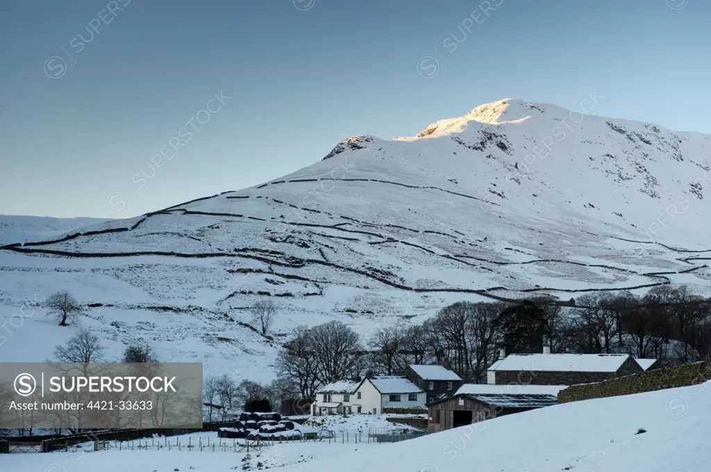 View of fell ridge in snow at sunset, Gibson Knott, near Grasmere, Lake District, Cumbria, England, winter