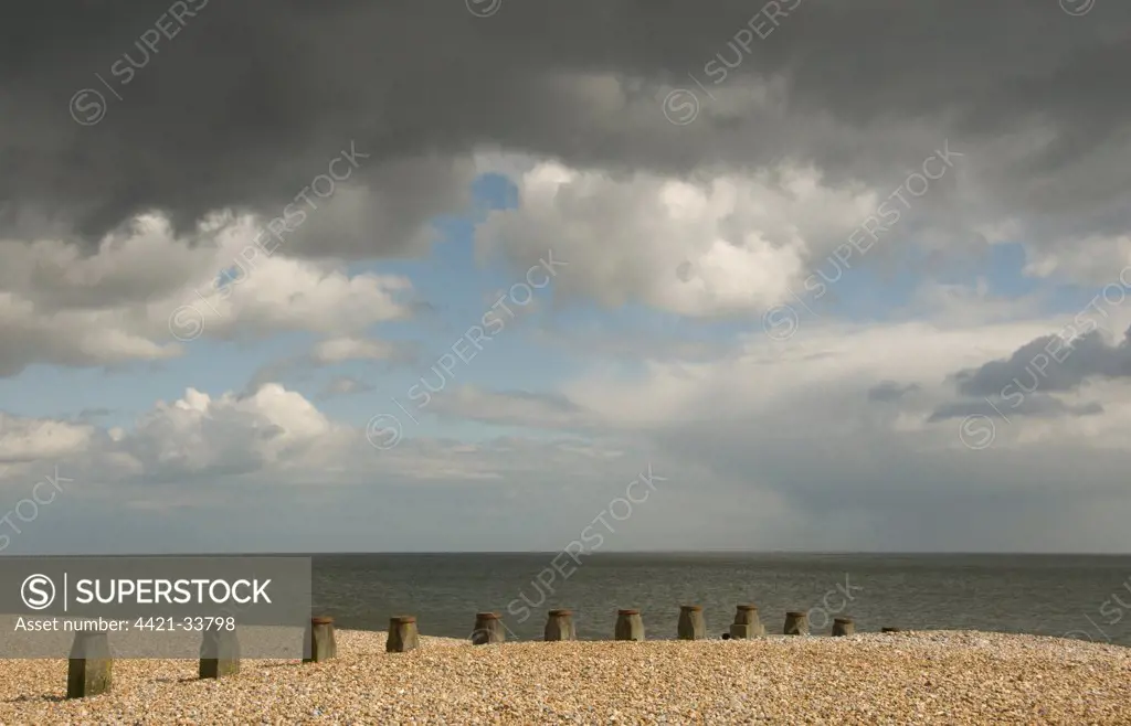 View of shingle beach and sea, stormclouds over sea, Eastbourne, East Sussex, England, april