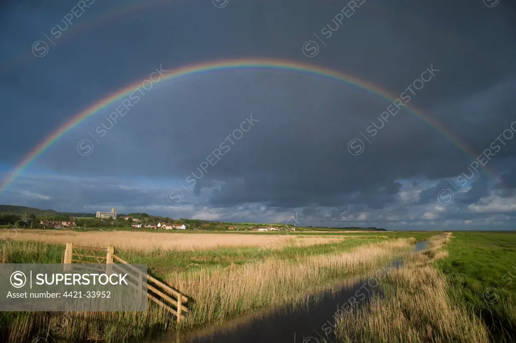 Rainbow over coastal grazing marsh habitat, Salthouse, North Norfolk, England, may