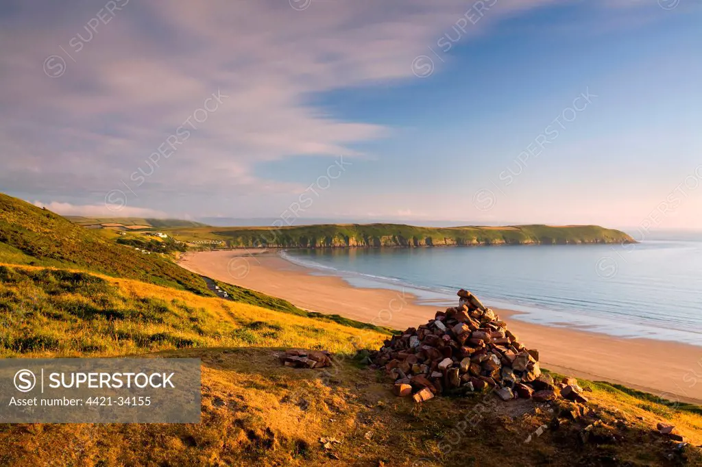 View of coastline with headland at sunset, viewed from Potters Hill, Baggy Point jutting out into Bristol Channel, Putsborough Beach, North Devon, England, june