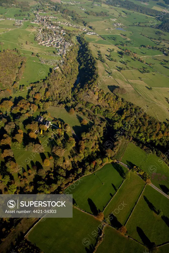 Aerial view of wooded valley, farmland and village, Bradford Dale, White Peak, Peak District, Derbyshire, England, september