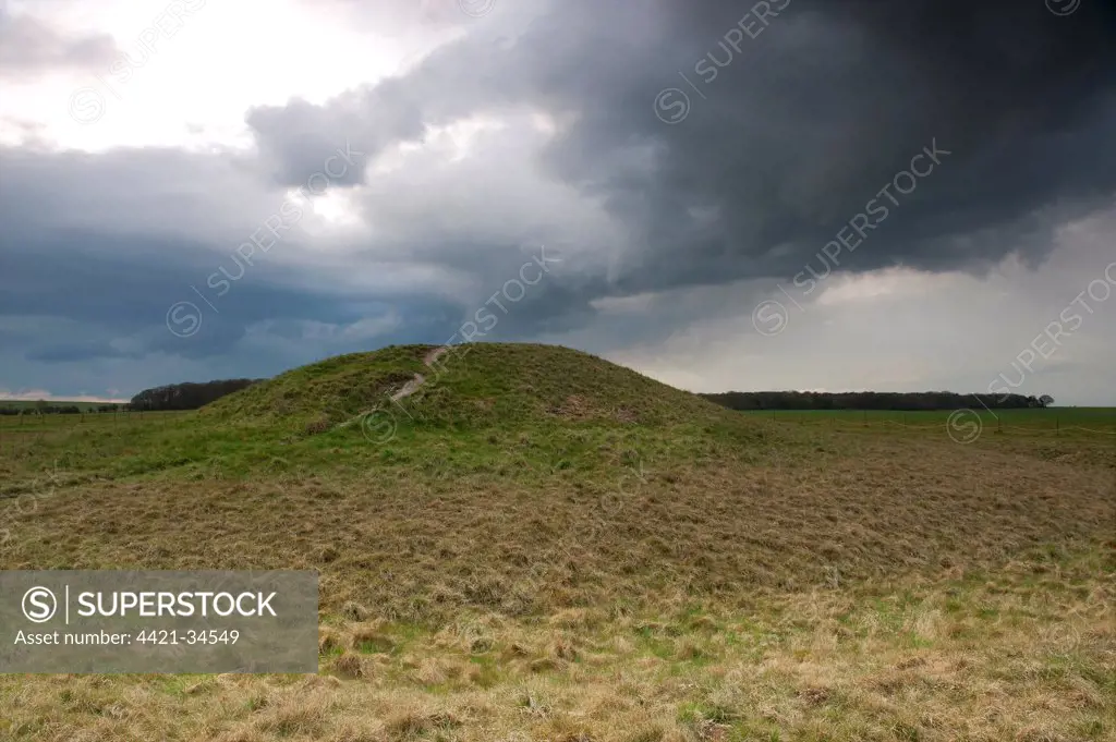 View of Bronze Age round barrow and approaching stormclouds, Normanton Down, Stonehenge, Salisbury Plain, Wiltshire, England, april