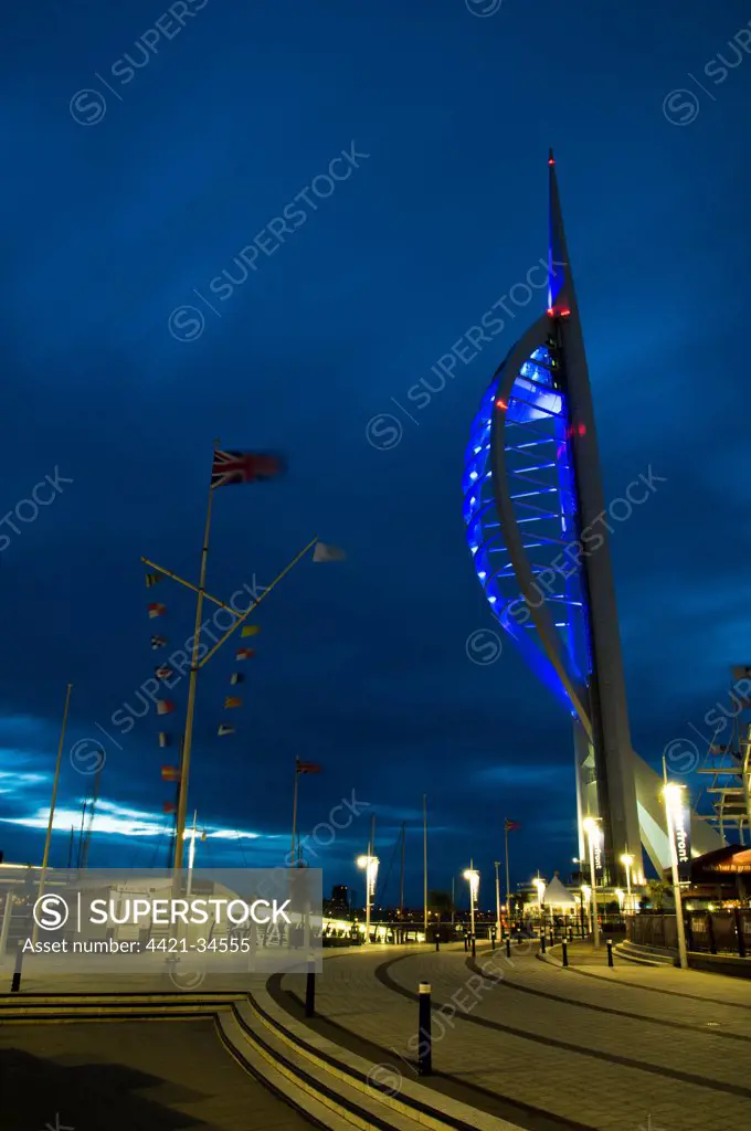 View of waterfront with Spinnaker Tower illuminated under stormclouds at dusk, Portsmouth Harbour, Portsmouth, Hampshire, England, august