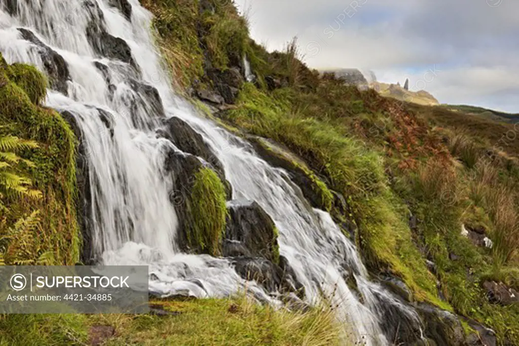 Moorland stream with waterfall, 'Old Man of Storr' rock pinnacle in background, Isle of Skye, Inner Hebrides, Scotland