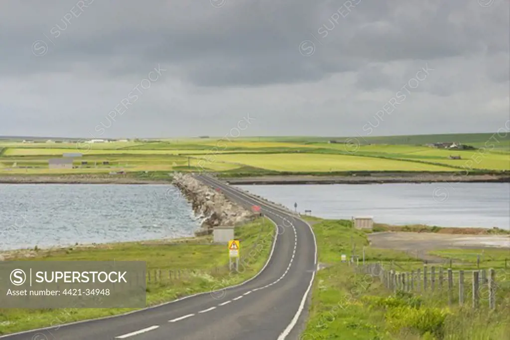 Road on causeway linking islands, originally built to close entrance and protect Scapa Flow, Churchill Barrier, between Burray and Mainland, Orkney, Scotland, june