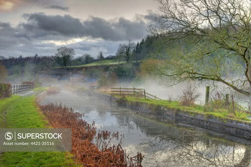View of mist over canal aquaduct at dusk, Shopshire Union Canal, Wern, Powys, Wales, december