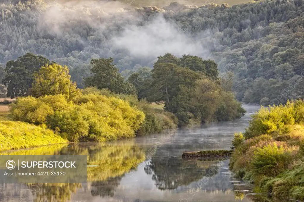 View of river with early morning mist clearing at dawn, Bigsweir, River Wye, Wye Valley, on border of Gloucestershire, England, Monmouthshire, Wales, august