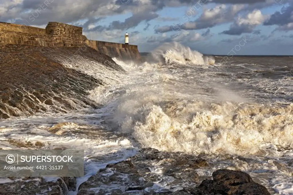 Coastal resort town seafront and lighthouse bombarded by waves, Porthcawl Pier, Porthcawl, Bristol Channel, South Wales, Wales, september