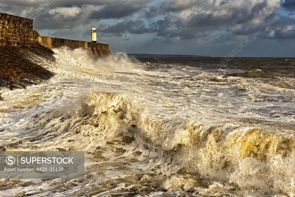Coastal resort town seafront and lighthouse bombarded by waves, Porthcawl Pier, Porthcawl, Bristol Channel, South Wales, Wales, september