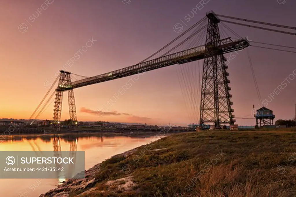 View of transporter bridge over river at twilight, Newport Transporter Bridge, River Usk, Newport, South Wales, Wales, september