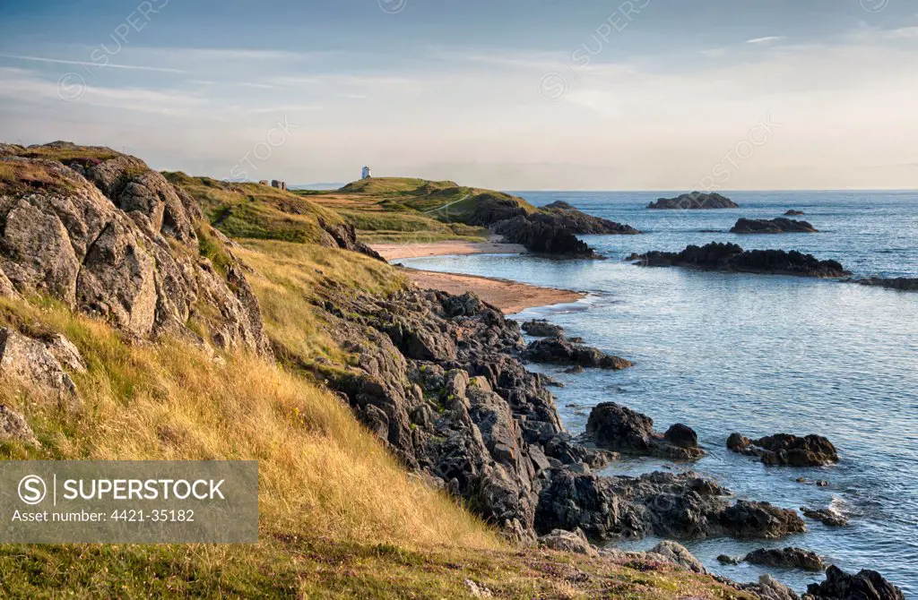 View of rocky coastline and beach on tidal island, Llanddwyn Island, Newborough Warren National Nature Reserve, Newborough, Anglesey, Wales, August