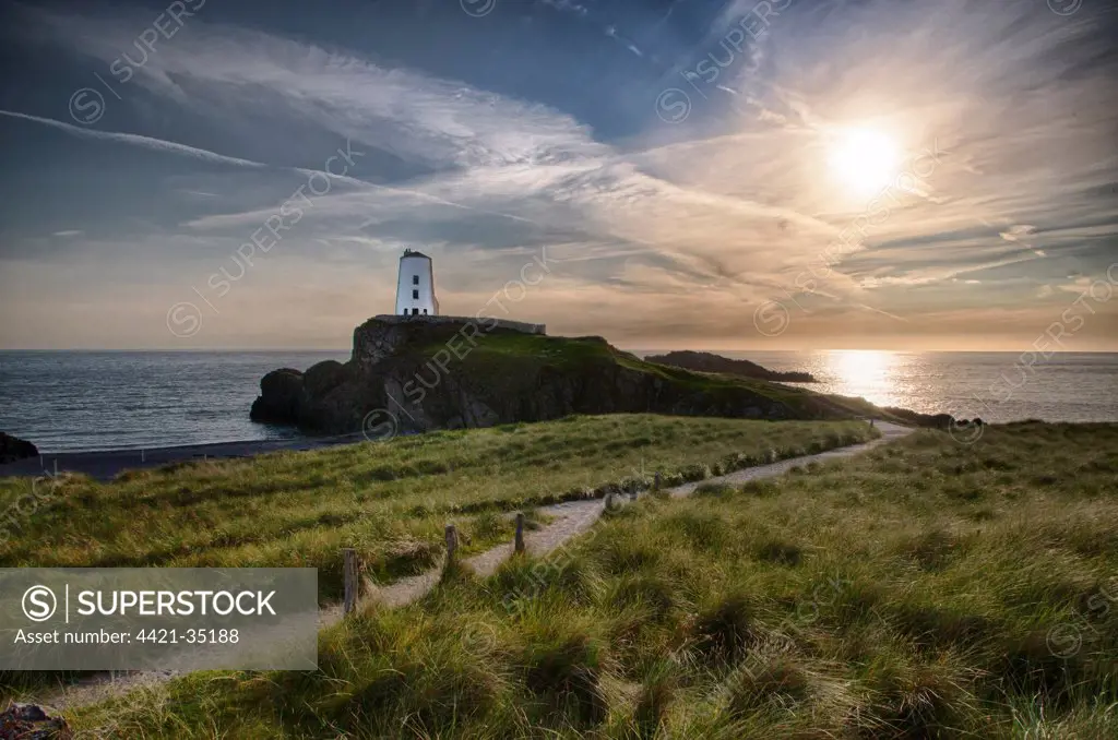 View of lighthouse and coastline on tidal island, Llanddwyn Island, Newborough Warren National Nature Reserve, Newborough, Anglesey, Wales, August