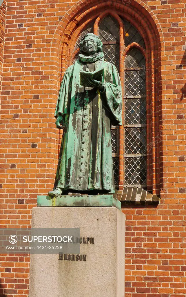 Statue of Hans Adolph Brorson (1694 - 1764), standing beside cathedral in historic town, Our Lady Maria Cathedral (Vor Frue Maria Domkirke), Ribe, Jutland, Denmark, may