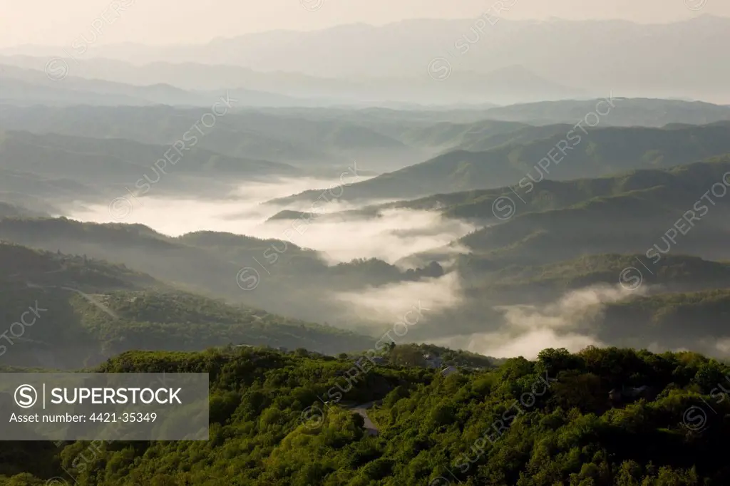 View across hills around Monodendri on misty dawn, Vikos N.P., Pindus Mountains, Epirus, Northwestern Greece