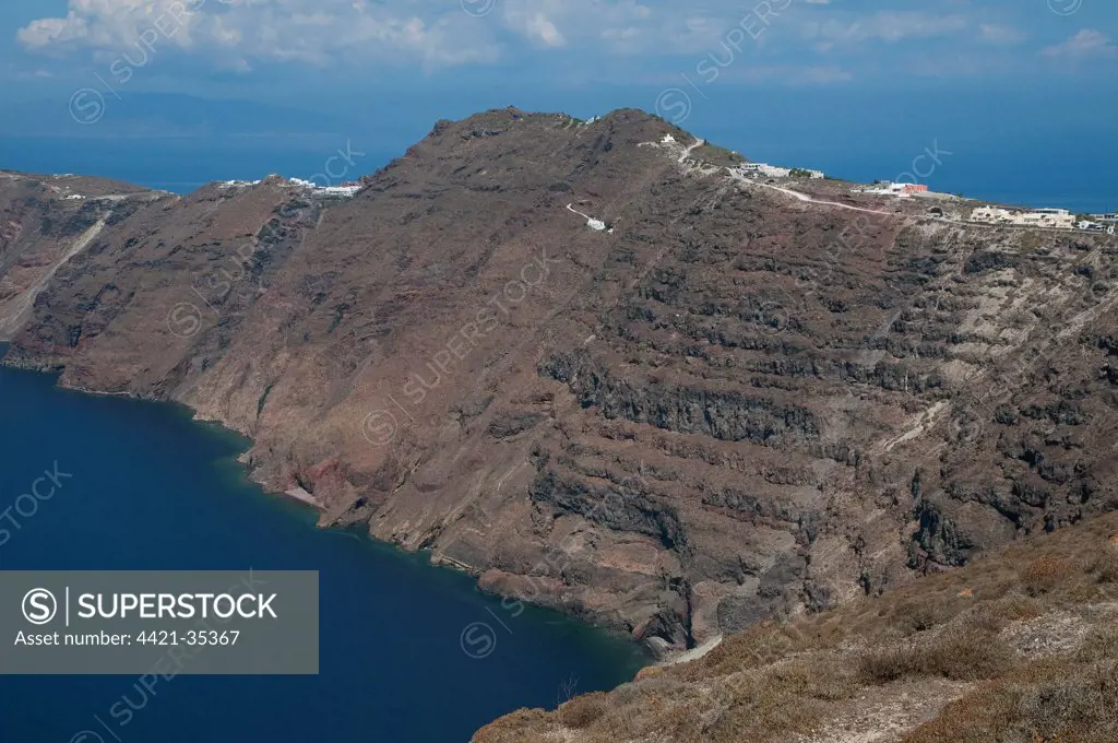 Rugged coastline with volcanic cliffs, near Oia, Santorini, Cyclades, Aegean Sea, Greece, September