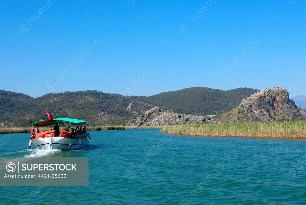 View of river with tourist boat, Dalyan River, Mugla Province, Turkey, april