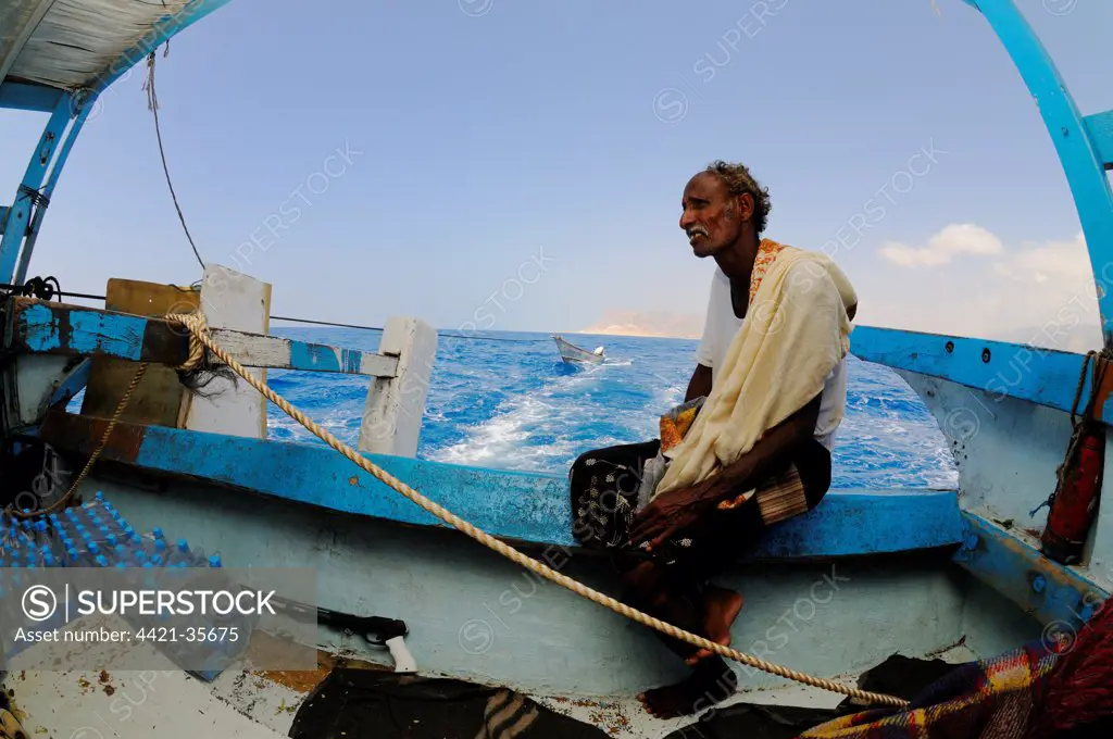 Local fisherman sitting on boat at sea, Socotra, Yemen, march