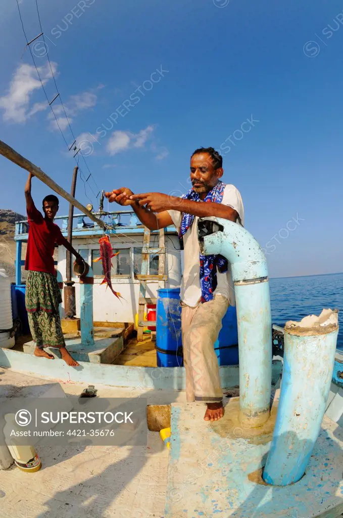 Local fishermen with catch on boat at sea, Socotra, Yemen, march