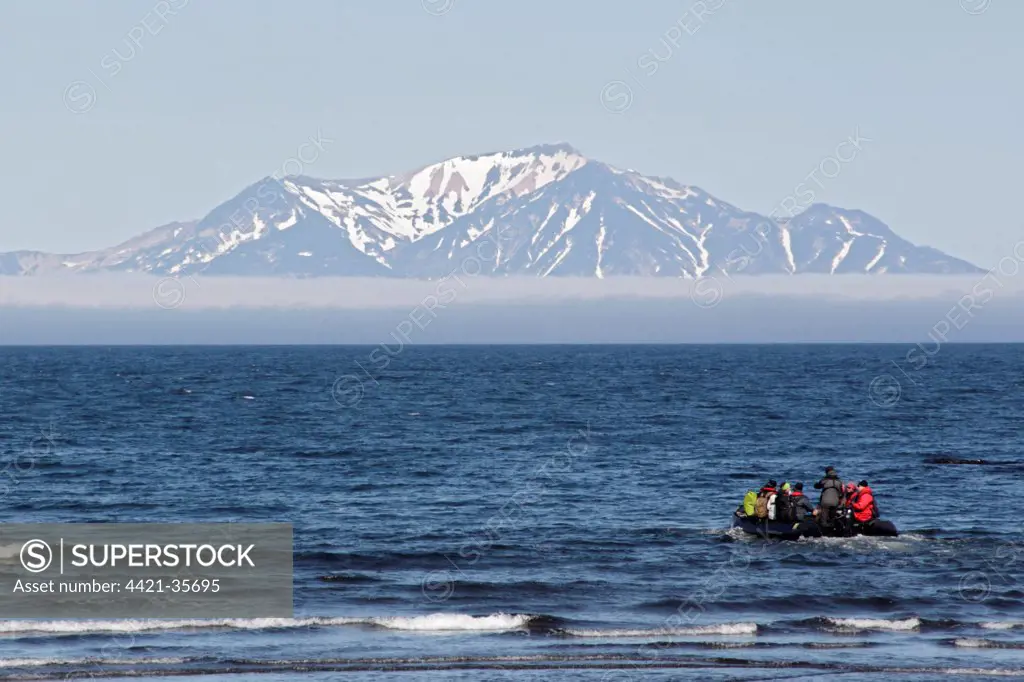 Zodiac inflatable boat with tourists at sea, Onekotan Island, Kuril Islands, Sea of Okhotsk, Sakhalin Oblast, Russian Far East, Russia, june