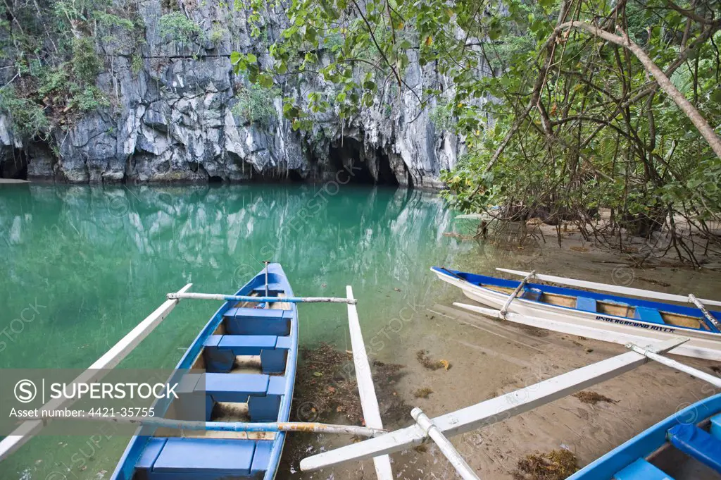Tourist boats outside cave entrance to subterranea river, Puerto Princesa Subterranean River N.P., Saint Paul Mountain Range, Palawan Island, Philippines