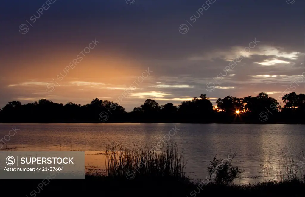 Setting sun over water near Lebala, Okavango Delta, Botswana