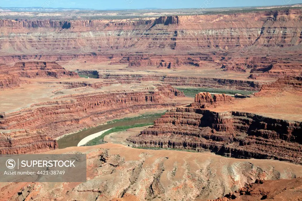 Colorado River seen here at Dead Horse Point has cut threw many layers of rock from Navajo Sandstone at the top to Rico formation nearest the river to form this view.