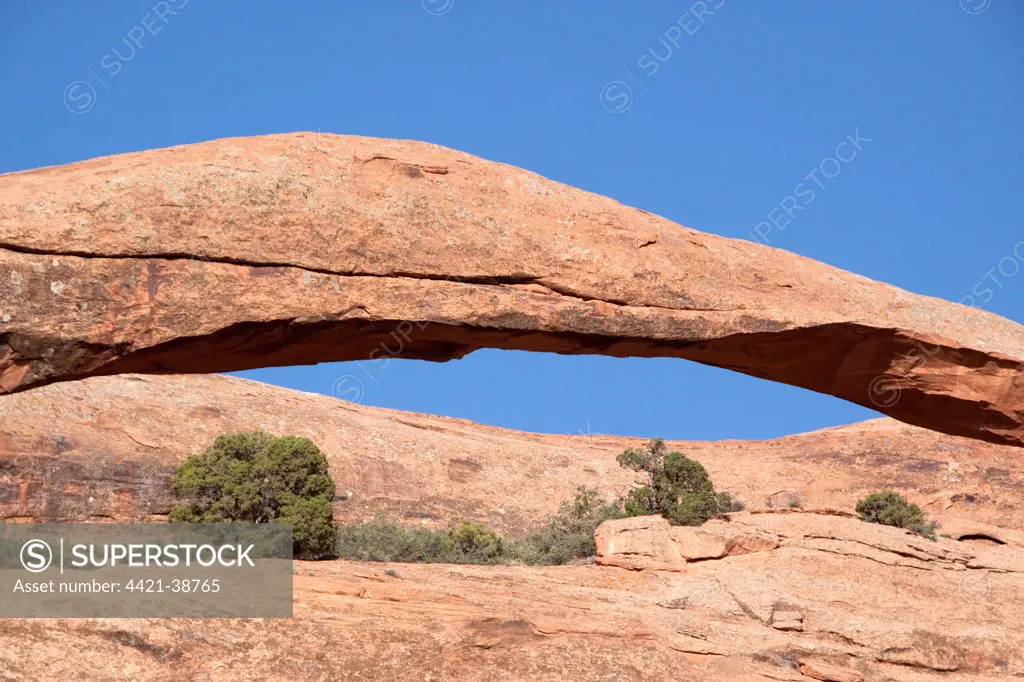 Close-up of the middle section of Landscape Arch in Arches National Park, Utah.  This arch is made from Entrada Sandstone which over time is eroded by water, ice and wind to form these amazing shapes.
