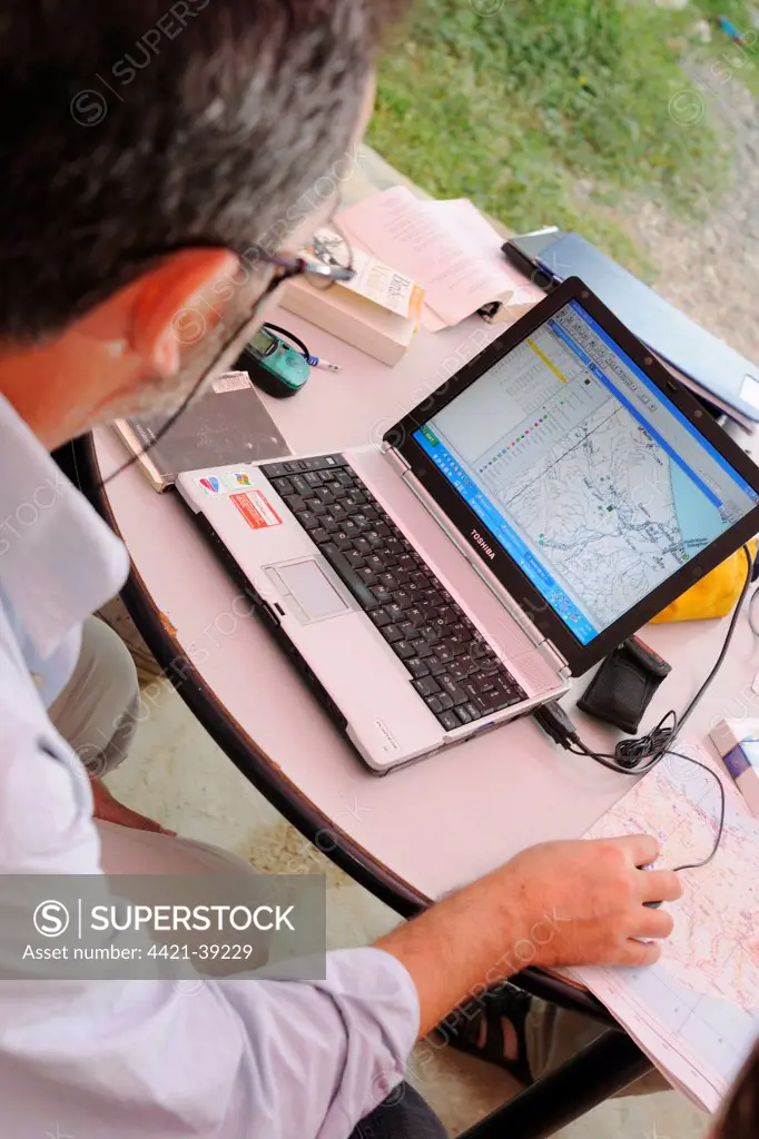 Researcher plotting survey data on GIS software, Socotra, Yemen, december