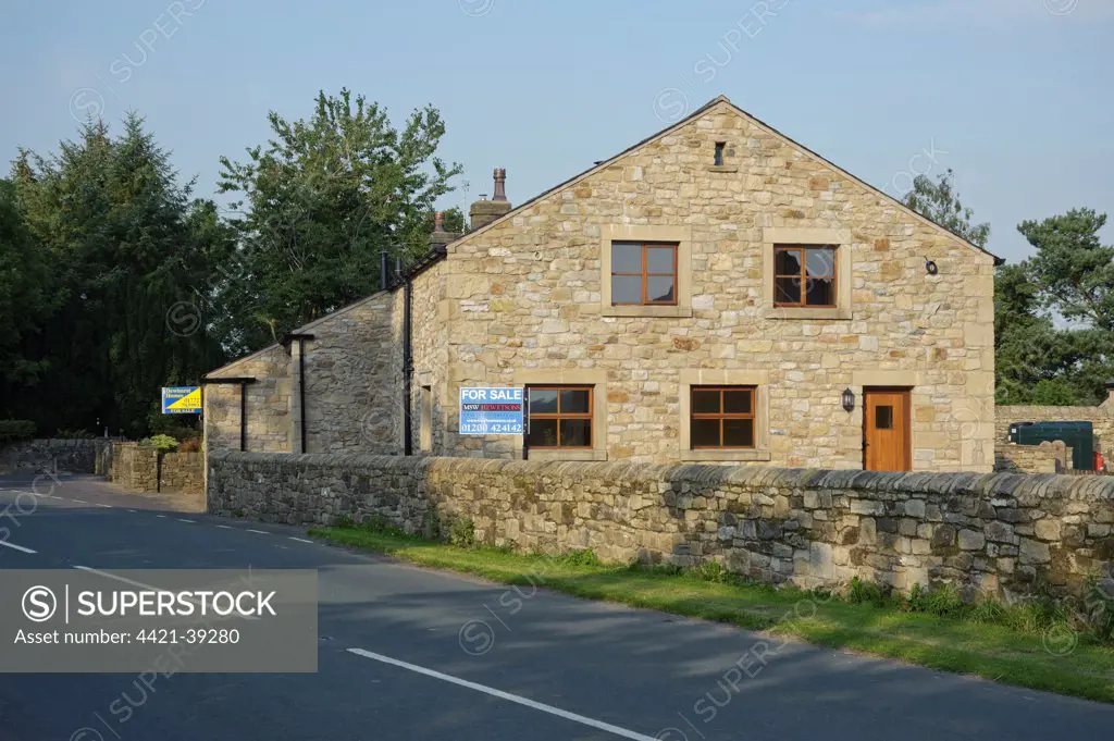 Farm buildings converted into housing, with 'For Sale' signs, Chipping, Lancashire, England, september