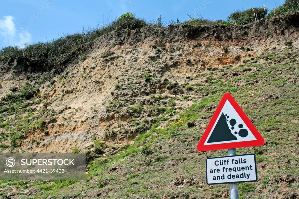 'Cliff falls are frequent and deadly' sign beside coastal cliff erosion, Dunwich, Suffolk, England, july