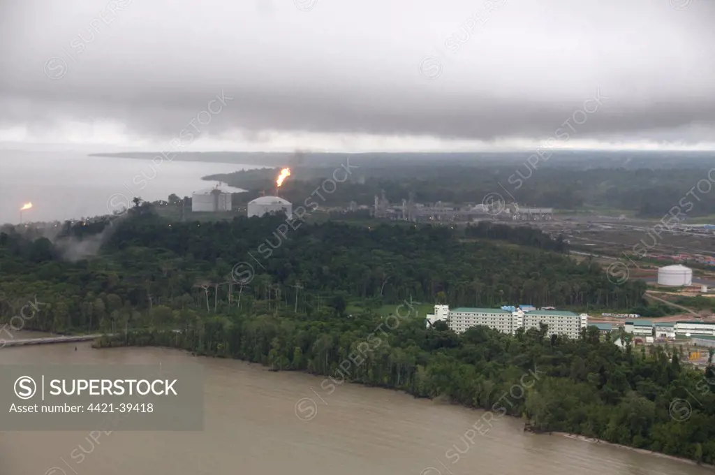 Flares by storage tanks in deforested area, Tangguh LNG (Liquified Natural Gas) Plant, Bintuni Bay, West Papua (Irian Jaya), Indonesia