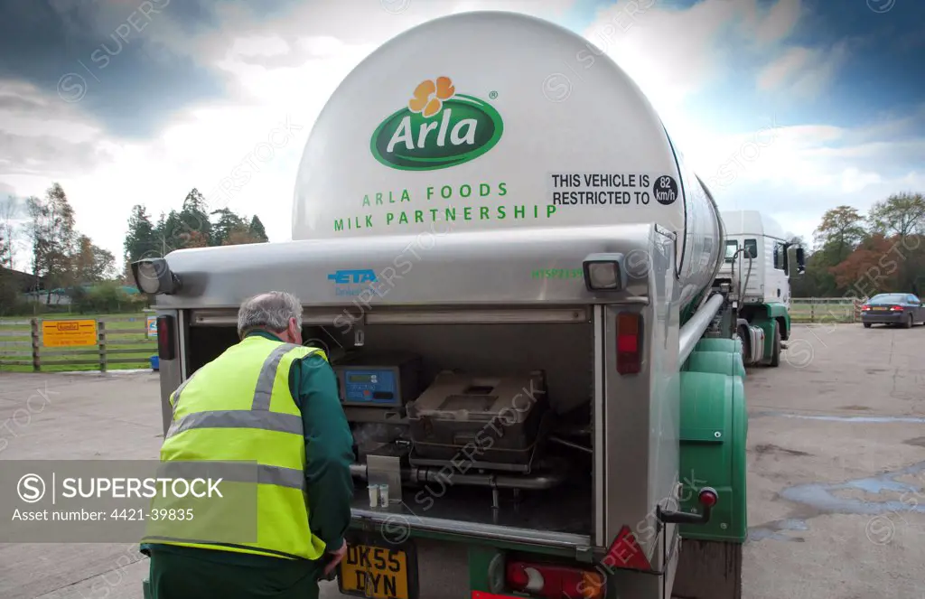 Arla milk tanker loading milk at dairy farm, man with milk samples, Dumfries, Scotland