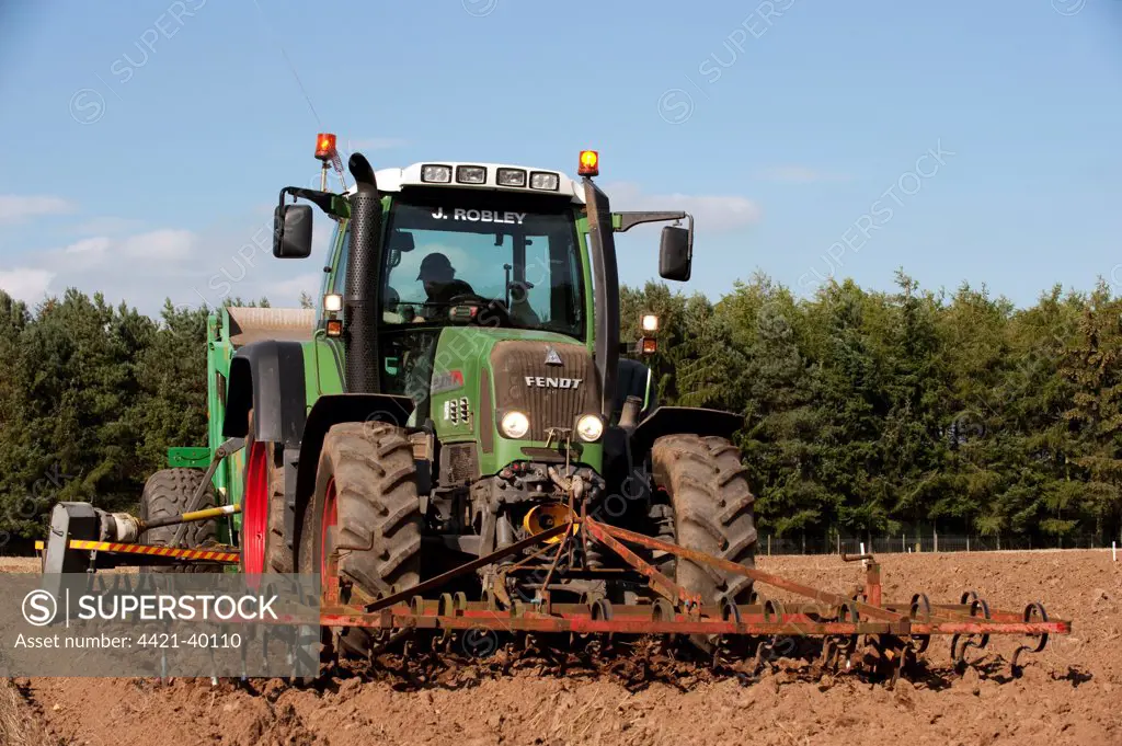 Fendt 716 tractor with stone picker, going over newly ploughed field, England, september