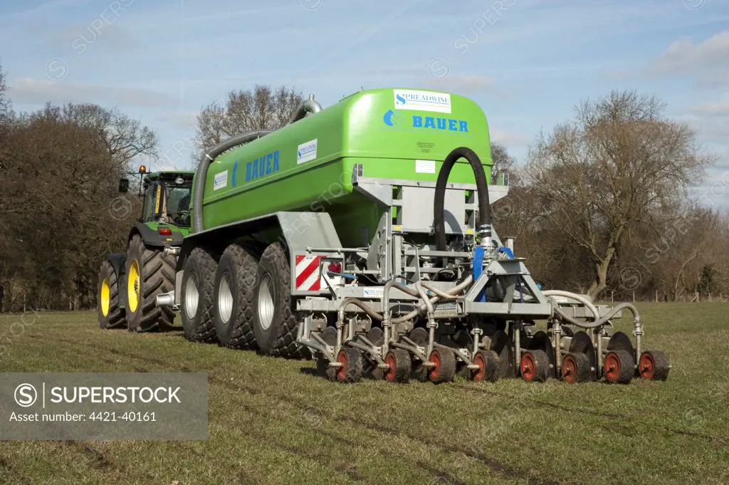 Bauer slurry tanker with Spreadwise slurry injector, injecting slurry into grassland, Cheshire, England, winter