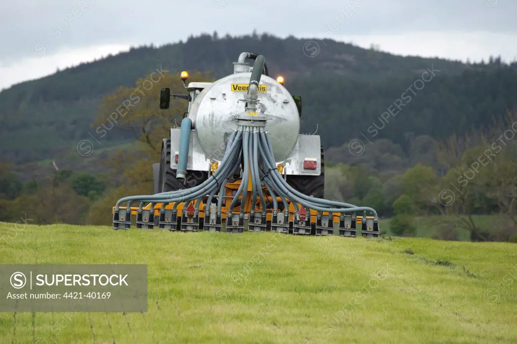 Slurry tanker and slurry injector, injecting slurry into grassland, Dumfries, Scotland, may