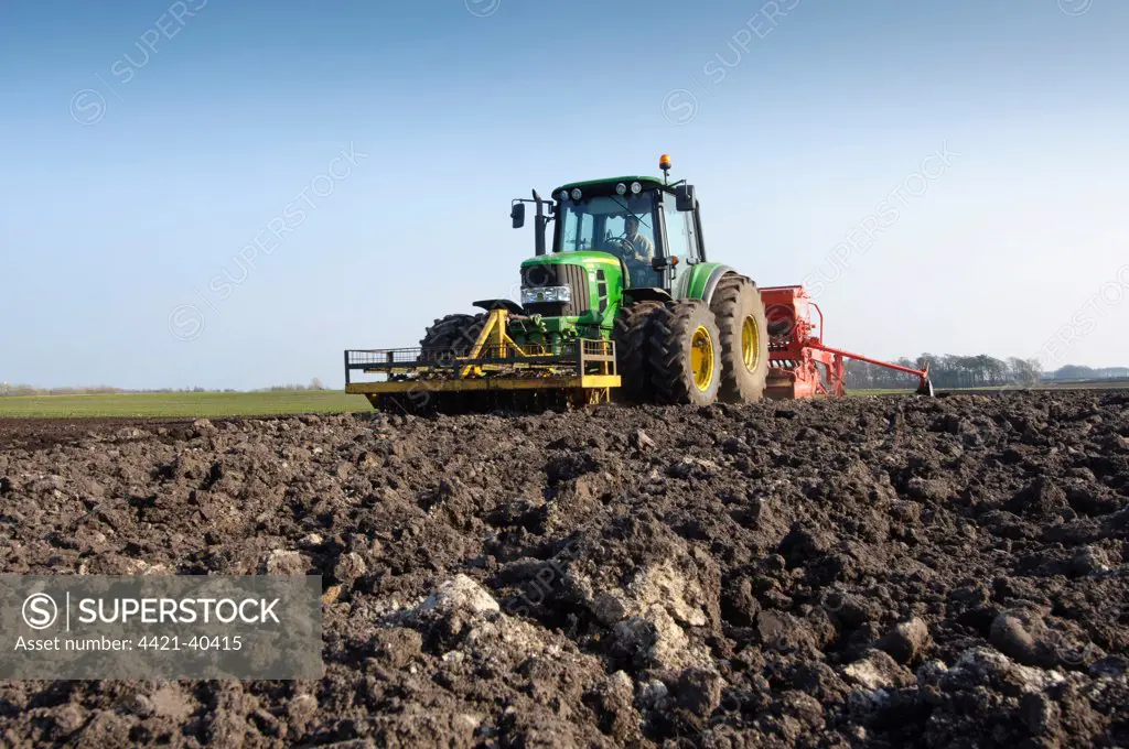 Tractor with seed drill, drilling Westminster spring barley, Pilling, Lancashire, England, march