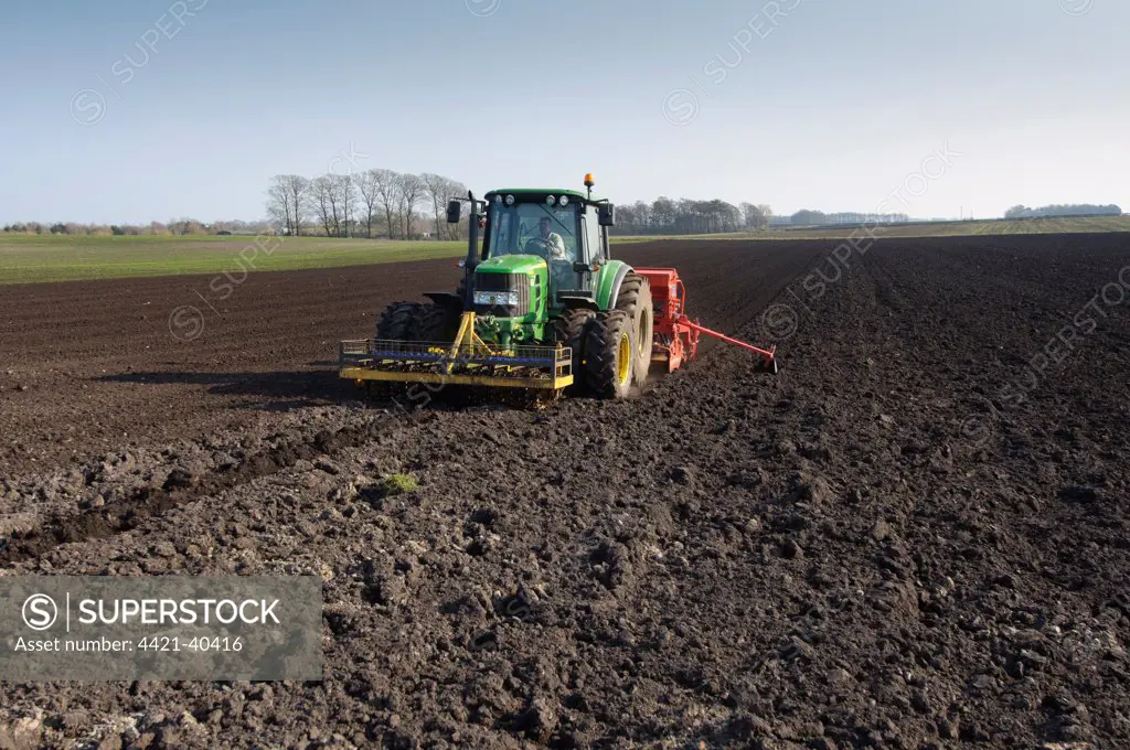 Tractor with seed drill, drilling Westminster spring barley, Pilling, Lancashire, England, march