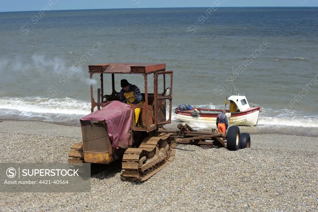Tractor landing fishing boat on beach, Weybourne, Norfolk, England, may