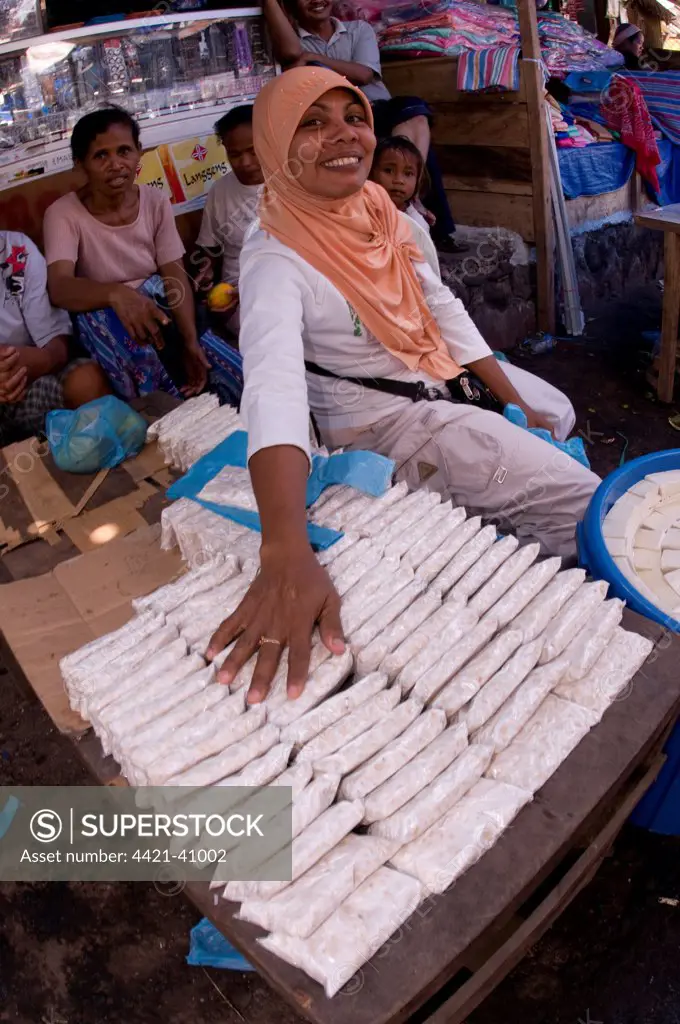 Woman selling soya bean products (tempe and tofu) at market, Kalabahi, Alor Island, Alor Archipelago, Lesser Sunda Islands, Indonesia