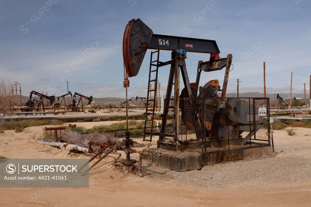 'Nodding donkey' oil pumps in oilfield, on slopes of mountain range, Temblor Range, near Taft, California, U.S.A.