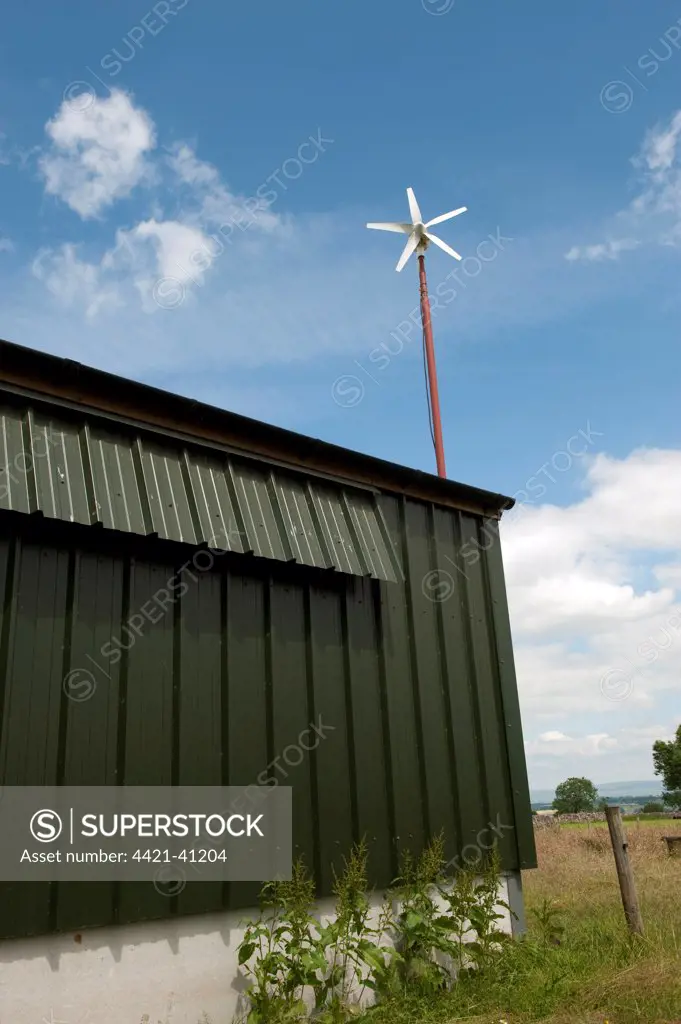 Wind turbine, powering free-range hen unit building, Cumbria, England, june