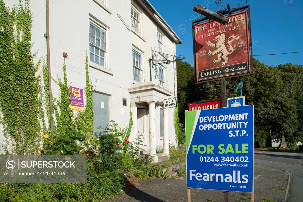 'For Sale' sign outside derelict public house, The Lion Hotel, Llanymynech, Shropshire, England, july