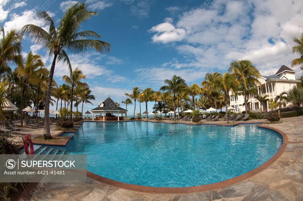 Swimming pool with palm trees and hotel building, Le Telfair Hotel, Bel Ombre, Southwest Mauritius