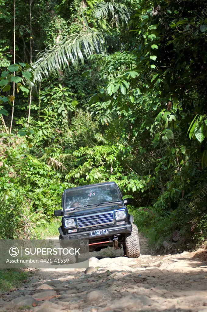 4x4 vehicle driving on track through rainforest, near Sukamade, Meru Betiri N.P., East Java, Indonesia