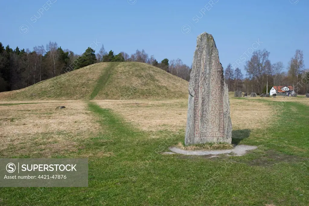 Rune stone beside ancient tumulus, Anundshog, (Anunds Hillock), Vasteras, Vastmanland, Sweden, april