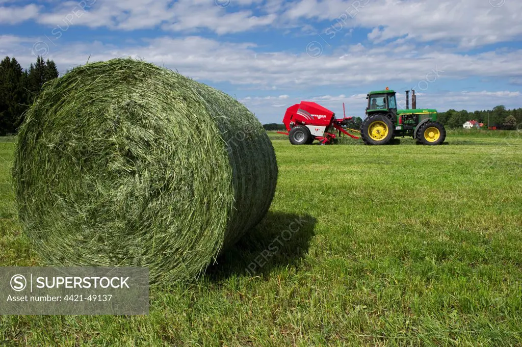 Round silage bale, with John Deere 4455 tractor and Welger baler, Sweden, june