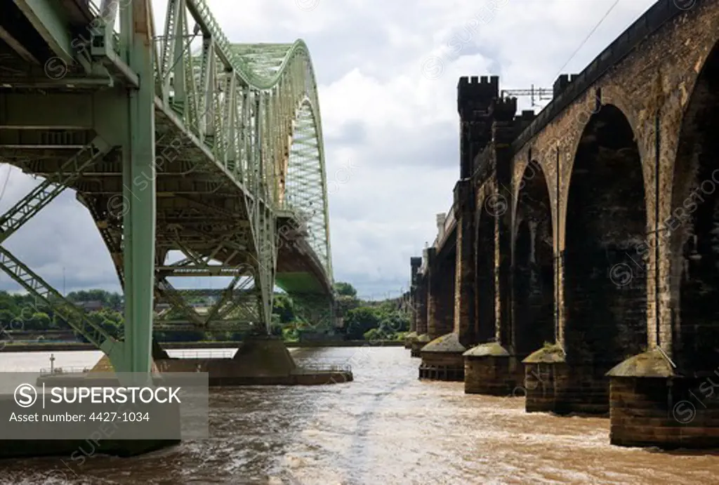 Railway bridge and the Runcorn-Widnes Bridge across the River Mersey, Merseyside, England